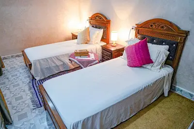 two beds in a hotel room with two beds sidx sidx sidx at Dar Lmrama Fes - Entire Guest House in Fès