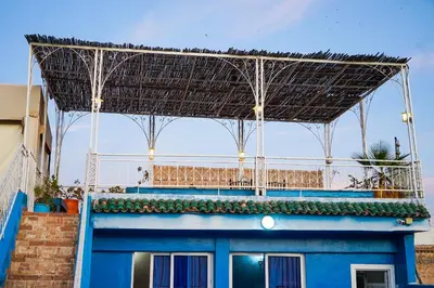 a large metal structure on top of a blue building at Dar Lmrama Fes - Entire Guest House in Fès