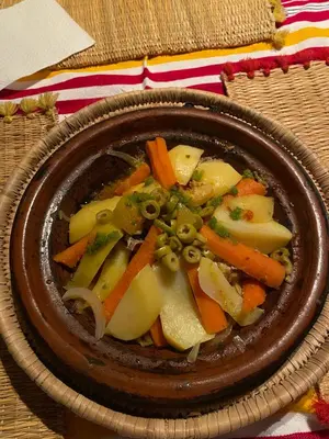 a bowl of food with vegetables in it on a table at Birgits Bed & Bistro, Garage für Biker kostenlos in Madkhal Meski