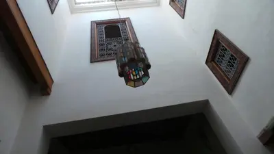 an overhead view of a light hanging from a ceiling at DAR SEFFAH au cœur de la Médina in Fès