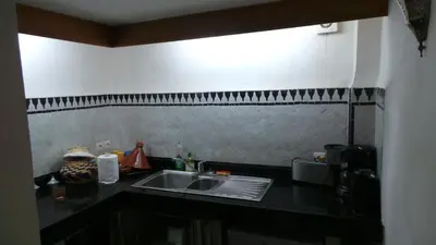 a kitchen with a sink and a counter top at DAR SEFFAH au cœur de la Médina in Fès