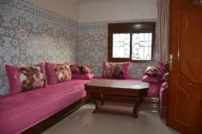 a living room with a pink couch and a window at Ozoud high standing appartment in Ouzoud