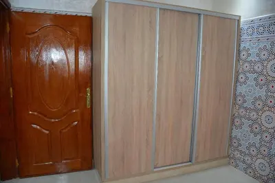 a pair of wooden cabinets next to a door at Ozoud high standing appartment in Ouzoud