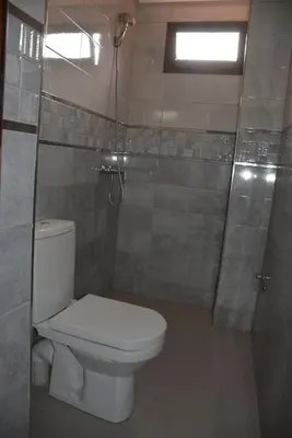 a bathroom with a toilet and a shower at Ozoud high standing appartment in Ouzoud