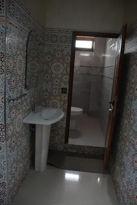 a bathroom with a shower and a sink and a toilet at Ozoud high standing appartment in Ouzoud
