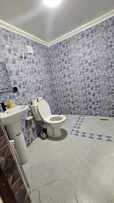a bathroom with a toilet and a sink at ESPACE INOV IMILCHIL in Imilchil