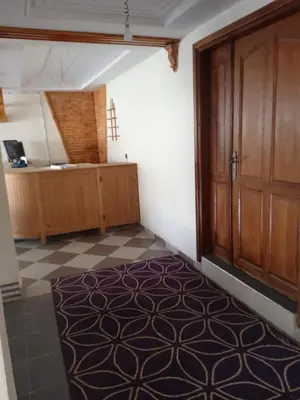 an empty room with a door and a tiled floor at ESPACE INOV IMILCHIL in Imilchil