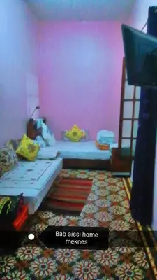 a room with two bunk beds and a pink wall at Bab aissi home in Meknès