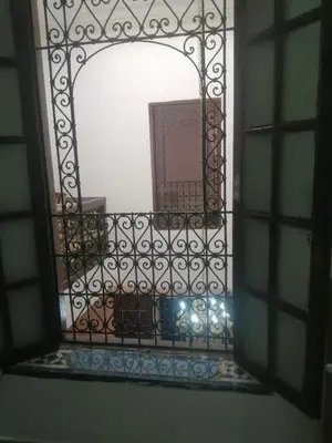 a mirror with a gate in a room at Bab aissi home in Meknès