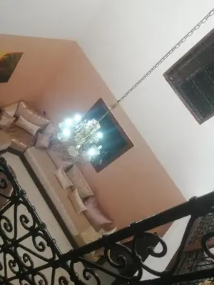 a living room with a couch and a tv at Bab aissi home in Meknès