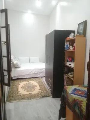 a bedroom with two bunk beds and a book shelf at Bab aissi home in Meknès