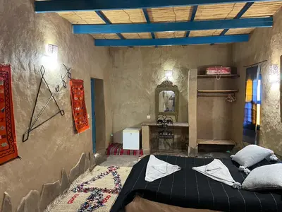a bedroom with a large bed in a room at Dar Oasis Moringa in Merzane