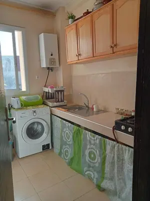 a kitchen with a washing machine and a sink at Two bedroom apartment in Ifrane