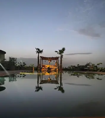 a wedding set up on top of a pool at Aghmat Lodge Guest house in Marrakech