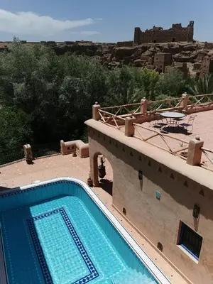 a swimming pool on top of a house with a view at Bab El Atlas in Kalaat MGouna