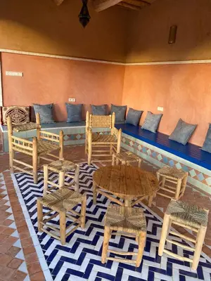 a living room with a couch and tables and chairs at Bab El Atlas in Kalaat MGouna