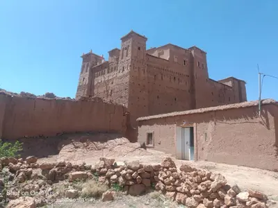 an old building with a castle in the background at Authentique Berbère in Agoulzi