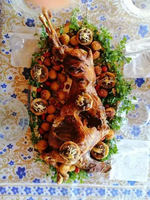 a plate of food with meat and vegetables on a table at GITE BOUKHALFA in Missour
