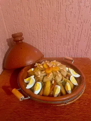 a bowl of food with eggs and mushrooms on a table at GITE BOUKHALFA in Missour