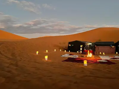 a tent in the desert with candles in the sand at Gambi Camp in Hassilabied