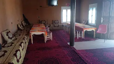 a room with a table and chairs and a room with a table and a table at Auberge camping café restaurant Relax Tazoulait in Bou Dib