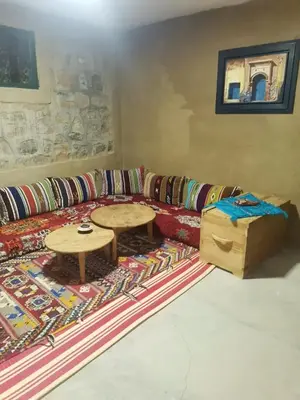 a living room with a couch and a table at Gîte Mourik in Aghbala