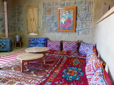 a living room with a couch and a table at Gîte Mourik in Aghbala