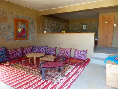 a living room with a couch and a table at Gîte Mourik in Aghbala