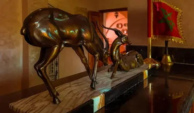 a bronze statue of a deer and a calf on a table at Hotel Rayyan l 'Escale in Ouarzazate