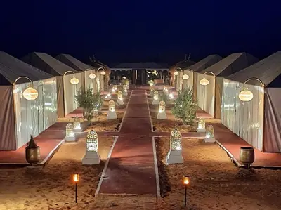 a row of candles in a tent at night at nomad luxury camp in Merzouga