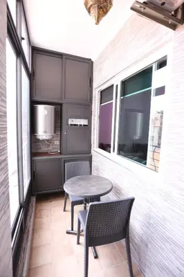 a small patio with a table and two chairs at APPARTEMENT AMIRA iFRANE in Ifrane