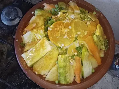 a bowl of food with broccoli and other vegetables at BiVOUAC CÔTE-IRIKI in Foum Zguid