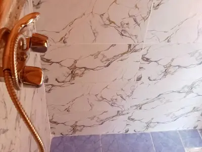 a bathroom with a marble wall and a phone at BiVOUAC CÔTE-IRIKI in Foum Zguid
