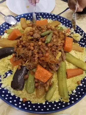a plate of food with beans and vegetables at BiVOUAC CÔTE-IRIKI in Foum Zguid