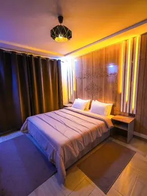 a bedroom with a large bed in a room at Hotel la Perle d'Arfoud in Erfoud