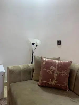 a couch with a pillow on it in a living room at Hotel la Perle d'Arfoud in Erfoud