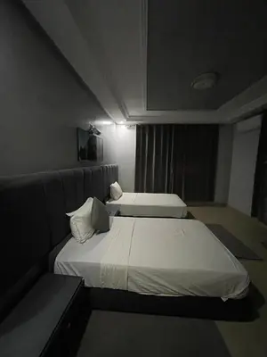 two beds in a hotel room with at Hotel la Perle d'Arfoud in Erfoud