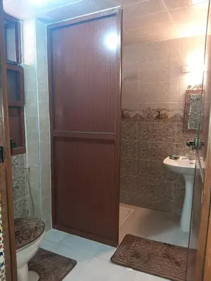 a bathroom with a shower with a toilet and a sink at Riad Mini Batha Family Fez Chez ABBADI in Fès