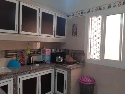 a kitchen with white cabinets and a counter top at Riad Mini Batha Family Fez Chez ABBADI in Fès