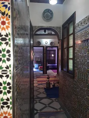 a hallway in a house with a tile floor at Riad Mini Batha Family Fez Chez ABBADI in Fès