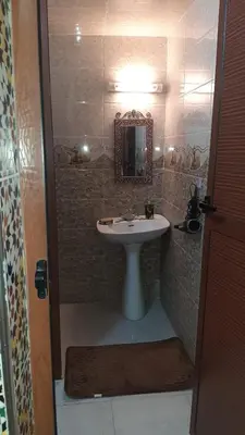 a bathroom with a sink and a mirror at Riad Mini Batha Family Fez Chez ABBADI in Fès
