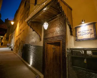 a door to a building with a sign on it at Riad Diamant De Fes in Fès