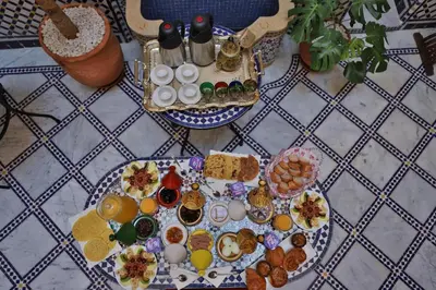 a table topped with plates of food on a table at Riad Diamant De Fes in Fès