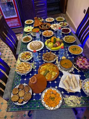 a table with many plates of food on it at Riad Diamant De Fes in Fès