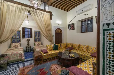 a living room with a couch and a table at Charmant appartement avec terrasse privee a fes medina in Fès