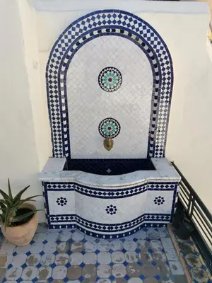 a blue and white chair sitting in a room at Charmant appartement avec terrasse privee a fes medina in Fès