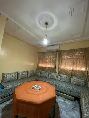 a living room with a couch and a table at Le bel abri in Meknès