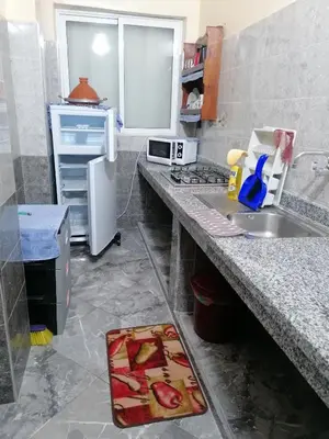 a kitchen with a sink and a refrigerator at Le bel abri in Meknès