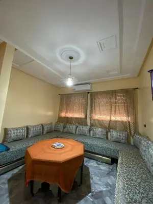 a living room with a couch and a table at Le bel abri in Meknès