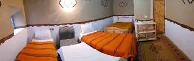a small bedroom with two beds in a room at Riad DAR outebba in Zaouïet Sidi Daoud